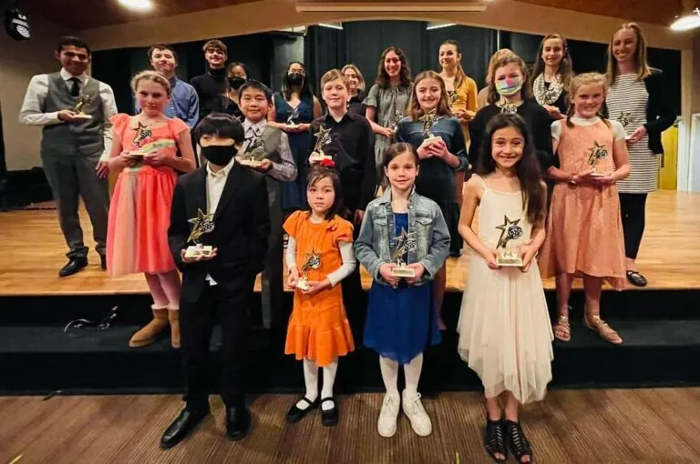 Students holding trophies at Altitunes music recital
