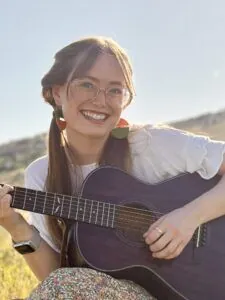 Brigitte Benson Altitunes music teacher with guitar