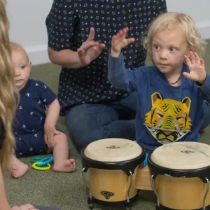 Kids and parents drumming together in Toe Tappin Toddlers group music class.