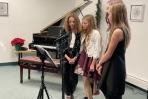 A group of students from Group voice class singing at the winter recital.